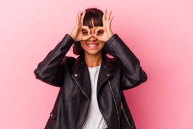 Pembe arka planda izole edilmiş genç melez kadın gözlerde sorun olmadığını gösteriyor.