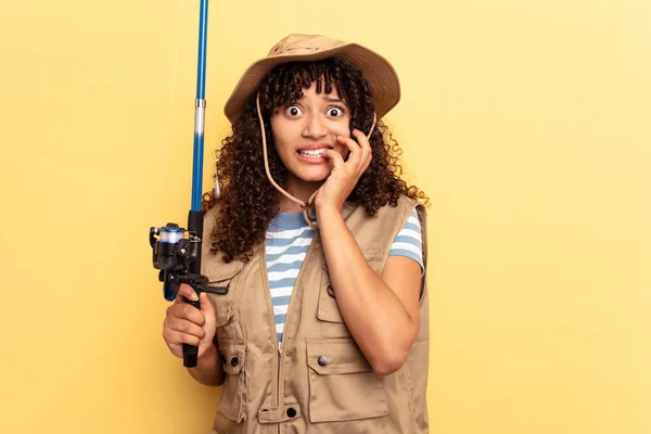 Young Mixed Race Fisherwoman Holding Rod Isolated Yellow Background Biting — Stock Photo, Image