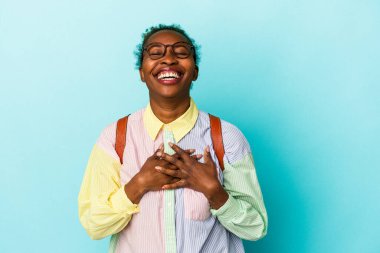 Genç Afro-Amerikalı Amerikalı bir kadın izole edilmiş arka planda gülüyor, ellerini yüreğine koyuyor, mutluluk kavramını koruyor..