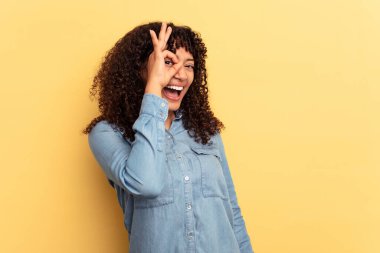 Sarı arka planda izole edilmiş genç melez bir kadın heyecanlı, tamam mı?.