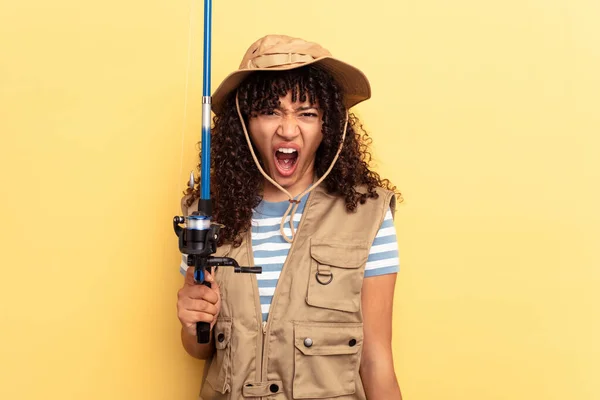 Young Mixed Race Fisherwoman Holding Rod Isolated Yellow Background Screaming — Stock Photo, Image