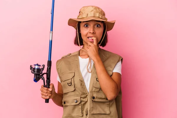 Young Mixed Race Fisherwoman Holding Rod Isolated Pink Background Biting — Stock Photo, Image