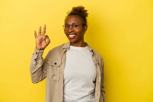 Young African American Woman Isolated Yellow Background Winks Eye Holds — Stock Photo, Image