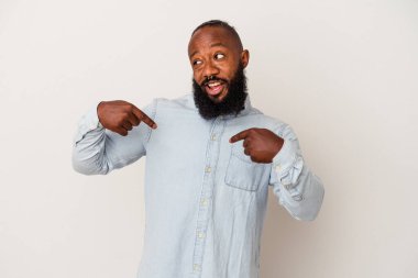 Pembe arka planda sakallı Afro-Amerikan bir adam parmağını gösterip gülümseyerek şaşırdı..