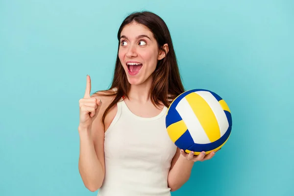 Mujer Joven Caucásica Jugando Voleibol Aislado Sobre Fondo Azul Apuntando — Foto de Stock