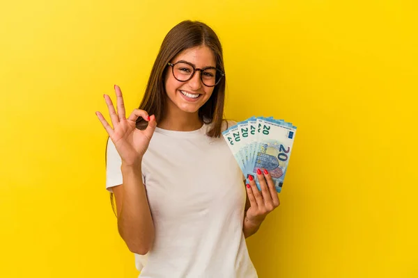 Young Caucasian Woman Holding Bills Isolated Yellow Background Cheerful Confident — Stock Photo, Image