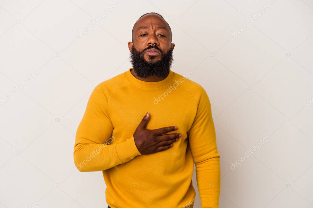 African american man with beard isolated on pink background taking an oath, putting hand on chest.