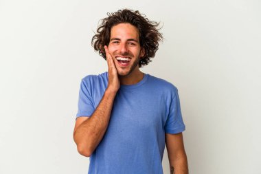 Beyaz arka planda izole genç beyaz adam yüksek sesle bağırıyor, gözleri açık ve elleri gergin tutuyor..