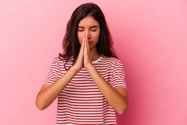 Pembe Arka Planda Izole Edilmiş Genç Beyaz Kadın Dua Ediyor — Stok fotoğraf