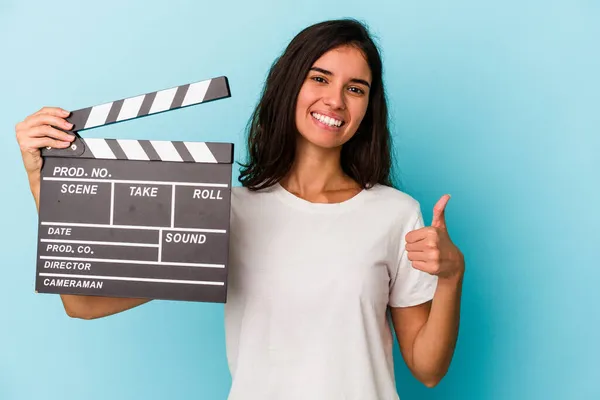 Young Caucasian Woman Holding Clapperboard Isolated Blue Background Smiling Raising — Stock Photo, Image