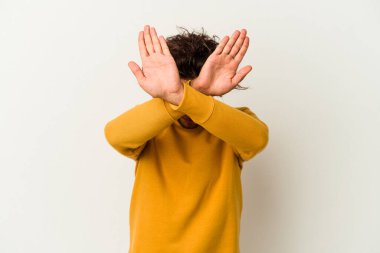 Beyaz arka planda izole genç beyaz adam iki kolu çapraz tutuyor, inkar kavramı.