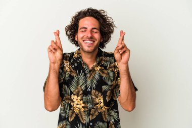 Beyaz arka planda izole genç beyaz adam şans dilemek için şans diliyor.