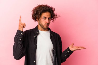 Kafkasyalı genç bir adam pembe fırında izole edilmiş ve elinde bir ürün var..