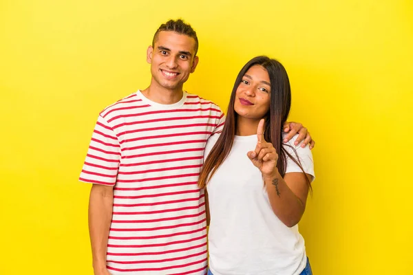 Jong Latijn Paar Geïsoleerd Gele Achtergrond Tonen Nummer Een Met — Stockfoto