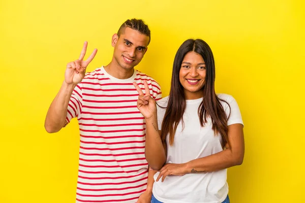 Jong Latijn Paar Geïsoleerd Gele Achtergrond Tonen Nummer Twee Met — Stockfoto