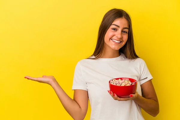 Young Caucasian Woman Holding Cereals Isolated Yellow Background Showing Copy — Stock Photo, Image