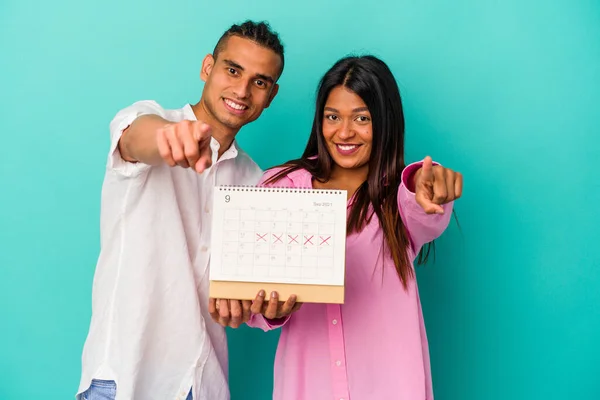 Jong Latijn Paar Met Een Kalender Geïsoleerd Blauwe Achtergrond — Stockfoto
