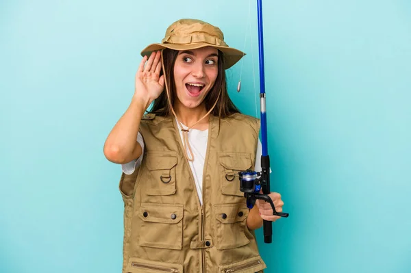 Young Caucasian Fisherwoman Isolated Blue Background Trying Listening Gossip — Stock Photo, Image