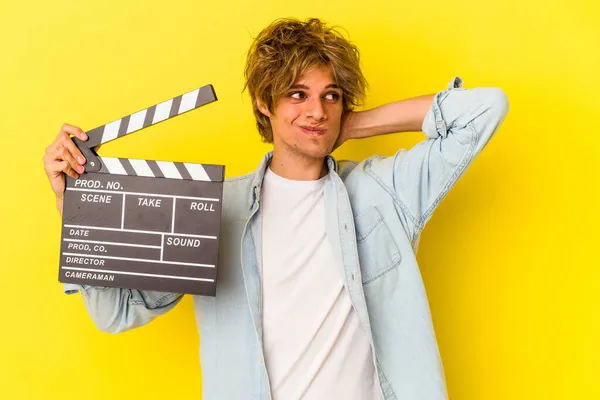 Young Caucasian Man Makeup Holding Clapperboard Isolated Yellow Background Touching — Stock Photo, Image