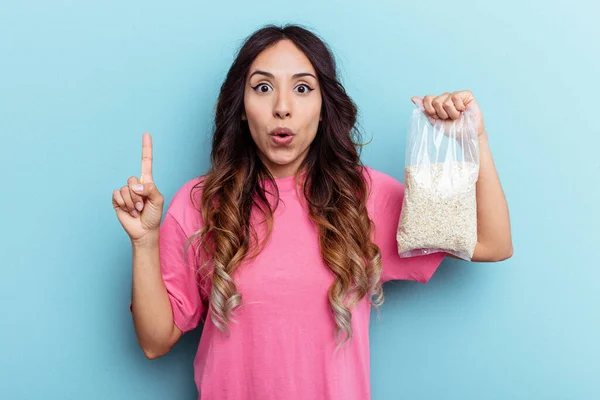 Young Mixed Race Woman Holding Oatmeal Isolated Blue Background Having — Stock Photo, Image