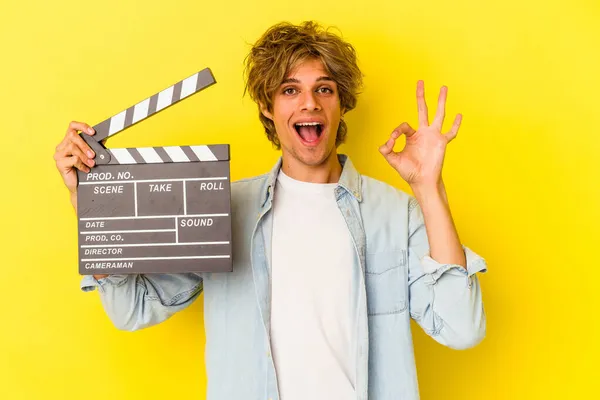 Young Caucasian Man Makeup Holding Clapperboard Isolated Yellow Background Cheerful — Stock Photo, Image