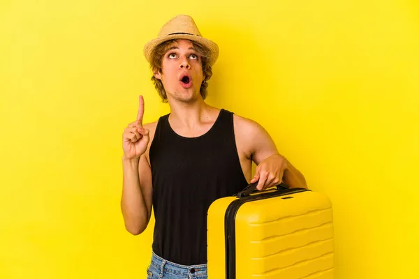 Young Caucasian Man Makeup Going Travel Isolated Yellow Background Pointing — Stock Photo, Image