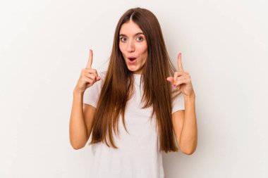 Beyaz arka planda izole edilmiş beyaz bir kadın ağzı açık bir şekilde üst tarafı işaret ediyor..