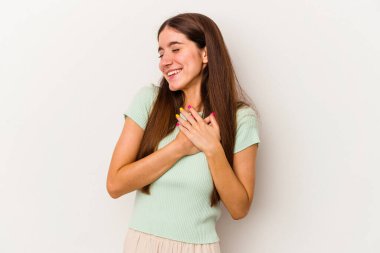 Beyaz arka planda izole edilmiş beyaz tenli genç bir kadın, dostane bir ifadeye sahip, avuçlarını göğsüne bastırıyor. Aşk konsepti.