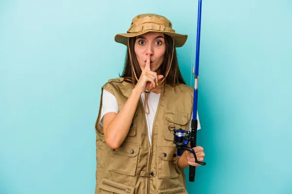 Young Caucasian Fisherwoman Isolated Blue Background Keeping Secret Asking Silence — Stock Photo, Image