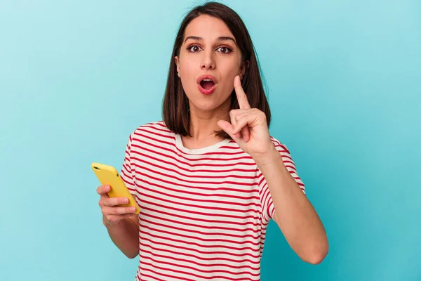 Young Caucasian Woman Holding Mobile Phone Isolated Blue Background Having — Stock Photo, Image
