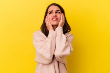 Sarı arka planda yalnız kalmış, ağlayan ve sızlanan beyaz bir kadın..