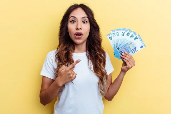 Young Mixed Race Woman Holding Bills Isolated Yellow Background Pointing — Stock Photo, Image