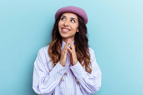 Young mexican woman isolated on blue background making up plan in mind, setting up an idea.