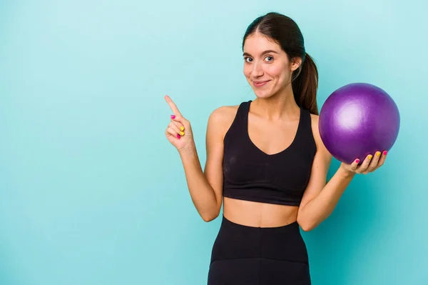 Young Caucasian Fitness Woman Holding Ball Isolated Blue Background Smiling — Stock Photo, Image