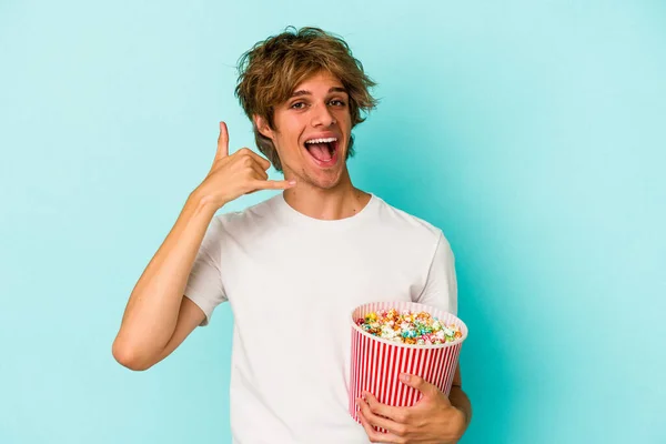 Młody Biały Mężczyzna Makijaż Trzymając Popcorn Odizolowany Niebieskim Tle Pokazując — Zdjęcie stockowe