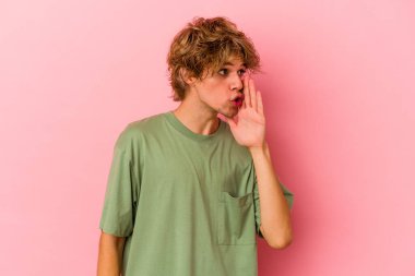 Pembe arka planda soyutlanmış beyaz makyajlı genç bir adam gizli bir sıcak fren haberi veriyor ve yan bakıyor.