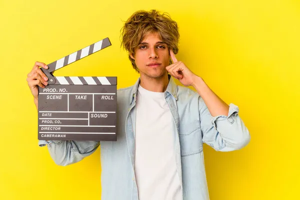 Mladý Běloch Make Upem Drží Clapperboard Izolované Žlutém Pozadí Ukazuje — Stock fotografie
