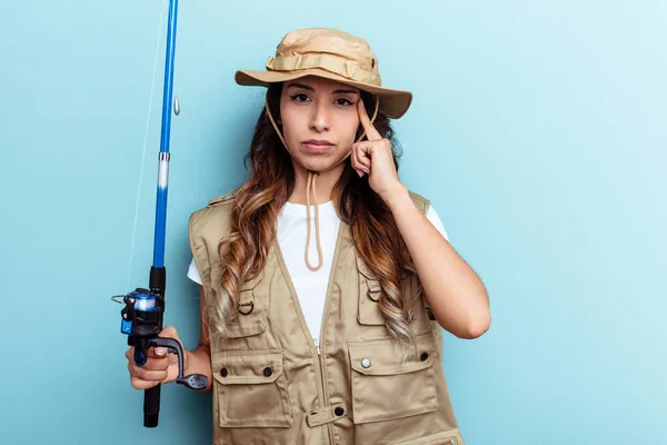 Young Mixed Race Fisherwoman Holding Rod Isolated Blue Background Pointing — Stock Photo, Image