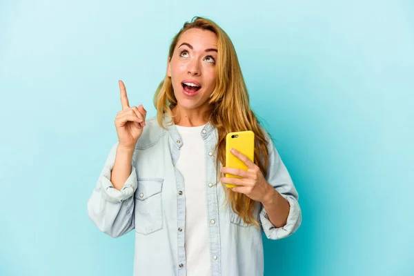 Elinde Cep Telefonu Olan Beyaz Bir Kadın Mavi Arka Planda — Stok fotoğraf