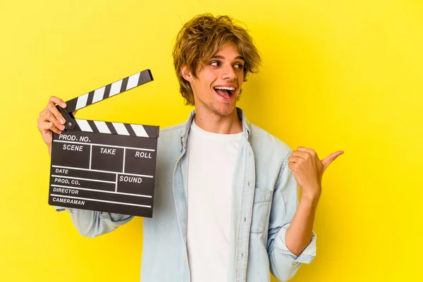 Young Caucasian Man Makeup Holding Clapperboard Isolated Yellow Background Points — Stock Photo, Image