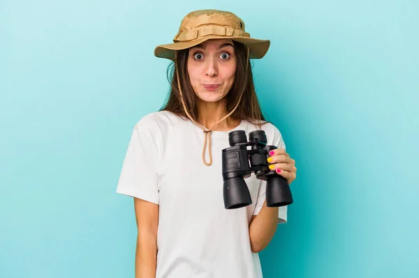 Jovem Explorador Caucasiano Mulher Segurando Binóculos Isolado Fundo Azul Encolhe — Fotografia de Stock