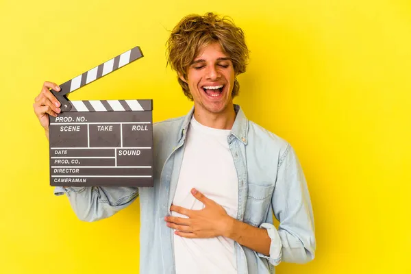 Młody Biały Człowiek Makijaż Gospodarstwa Clapperboard Izolowane Żółtym Tle Śmiech — Zdjęcie stockowe