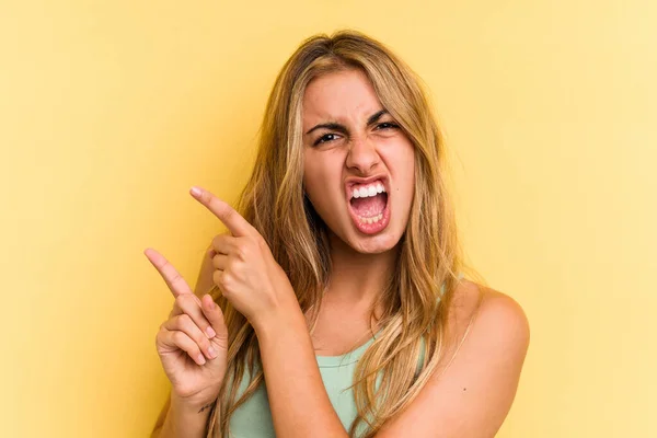 Young Caucasian Blonde Woman Isolated Yellow Background Pointing Forefingers Copy — Stock Photo, Image
