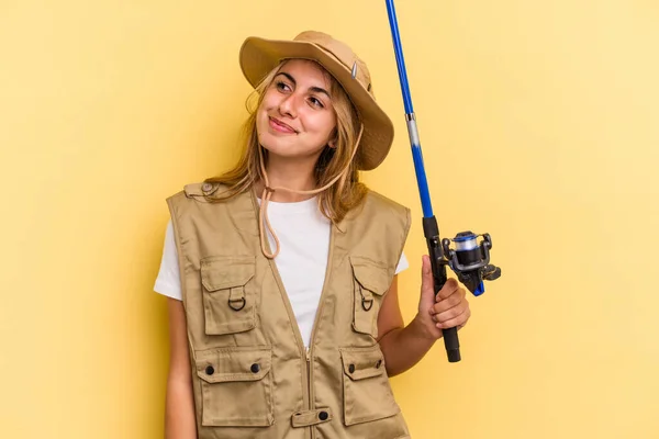 Young Caucasian Blonde Fisherwoman Holding Rod Isolated Yellow Background Dreaming — Stock Photo, Image