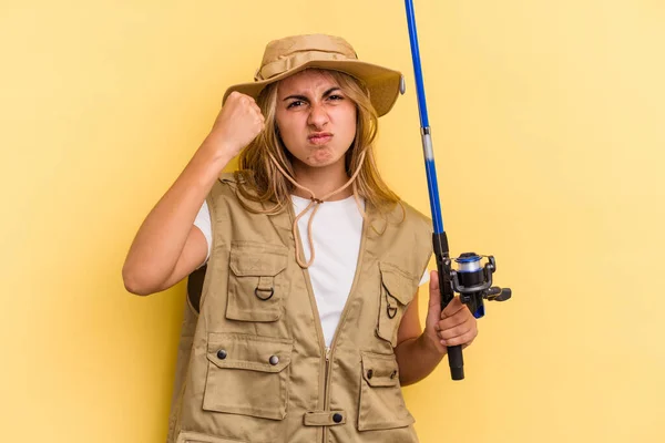 Young Caucasian Blonde Fisherwoman Holding Rod Isolated Yellow Background Showing — Stock Photo, Image