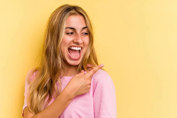 Young Caucasian Blonde Woman Isolated Yellow Background Looks Aside Smiling — Stock Photo, Image