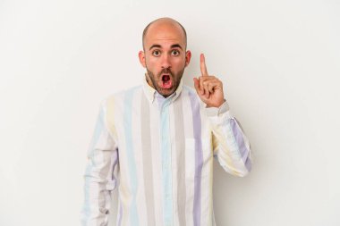 Genç kel adam beyaz arka planda izole edilmiş. Ağzı açık, üst tarafı işaret ediyor..