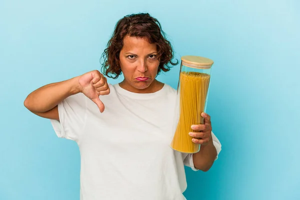 Middle Age Latin Woman Holding Pasta Jar Isolated Blue Background — Photo