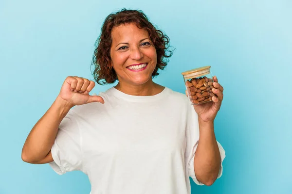 Young Mixed Race Woman Holding Almond Jar Isolated Blue Background — Fotografia de Stock