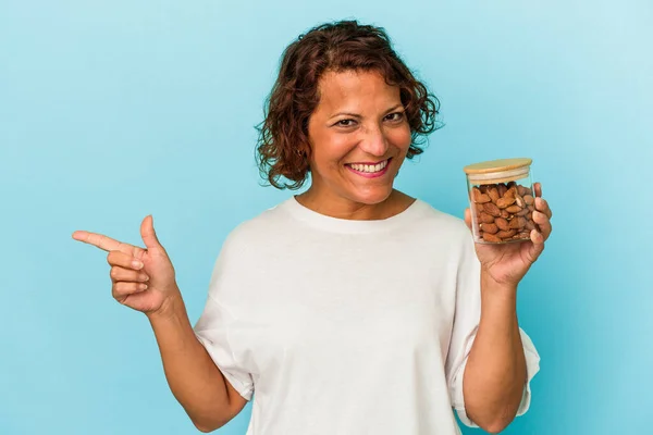 Young Mixed Race Woman Holding Almond Jar Isolated Blue Background — Fotografia de Stock